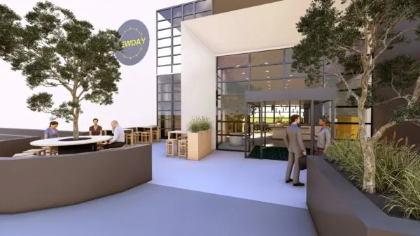 Moderne buitenruimte bij kantoorpand aan de Marten Meesweg met zitplaatsen, groen en het logo van ‘Newday’ op de gevel.